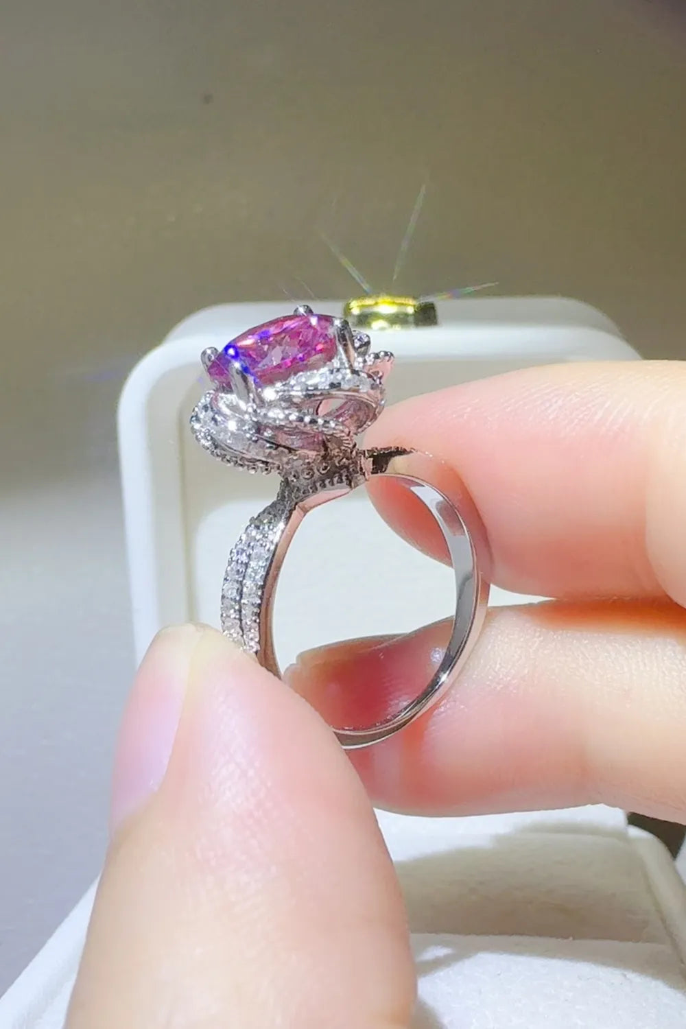 Stunning 2 carat moissanite flower ring featuring a pink center stone and sparkling accents