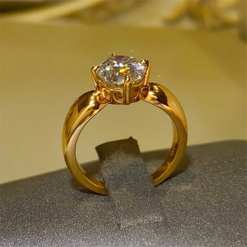 Elegant gold 2 carat moissanite ring with a brilliant cut stone in a unique setting