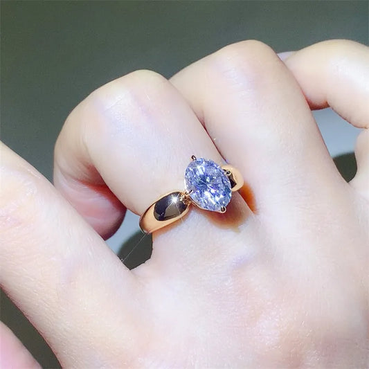 Trendsi 2 carat moissanite ring set in a sleek gold band, showcasing its brilliance on a hand.