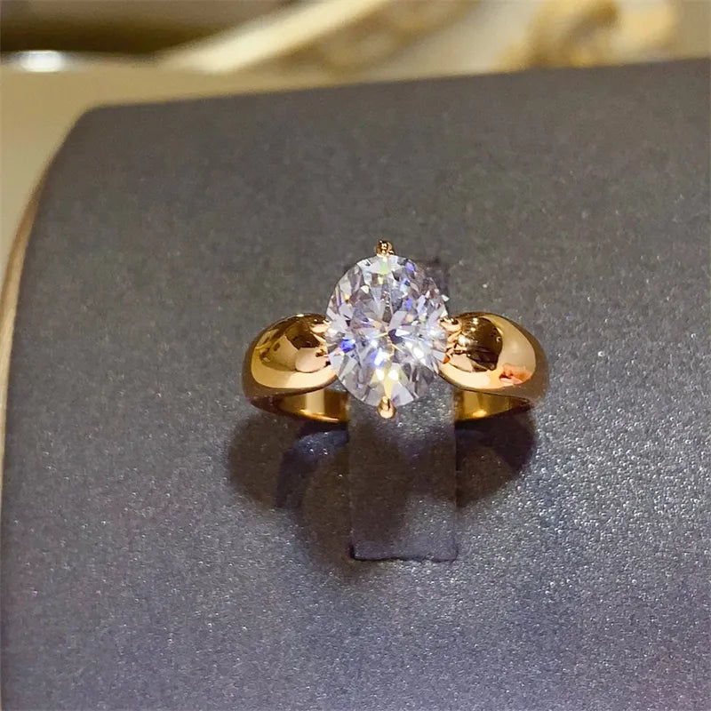 Elegant gold band featuring a stunning 2 carat moissanite ring with an oval center stone