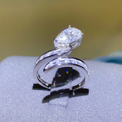 Elegant silver 3 carat moissanite ring with a twist design and sparkling stones on the band