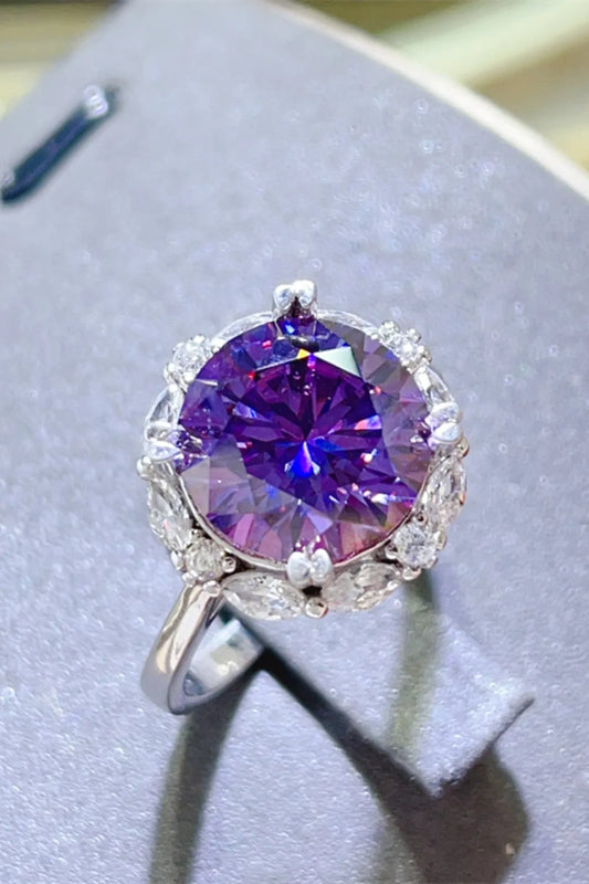 Stunning 5 carat moissanite ring featuring a vibrant purple stone surrounded by sparkling accents