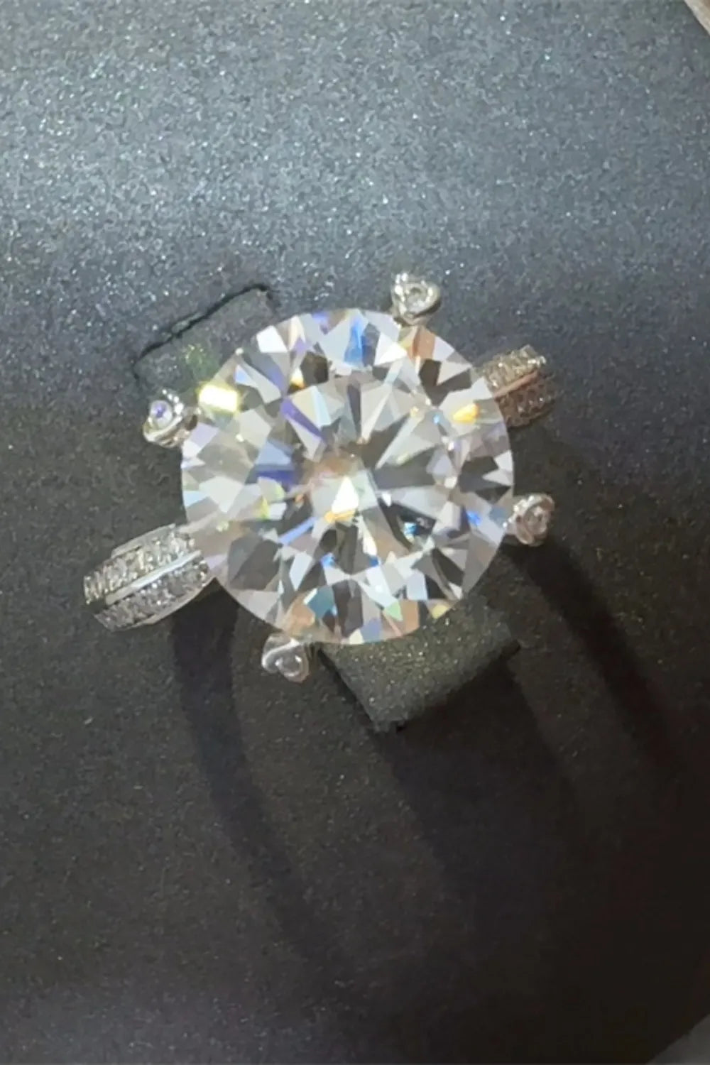Stunning 5 carat moissanite ring with a sparkling round center stone and detailed band design