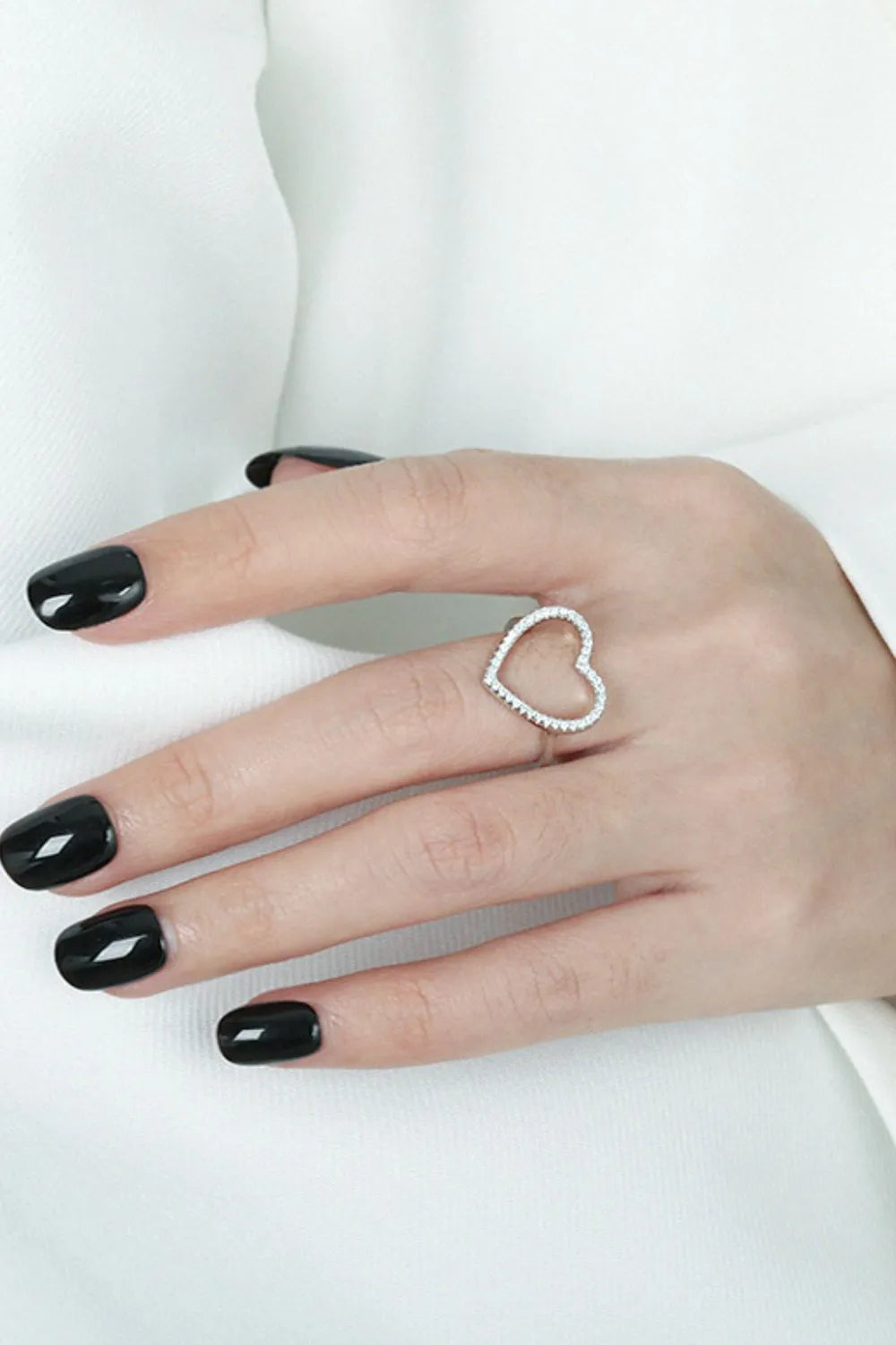 Trendsi 925 sterling silver heart ring with a delicate open design worn on a well-manicured hand