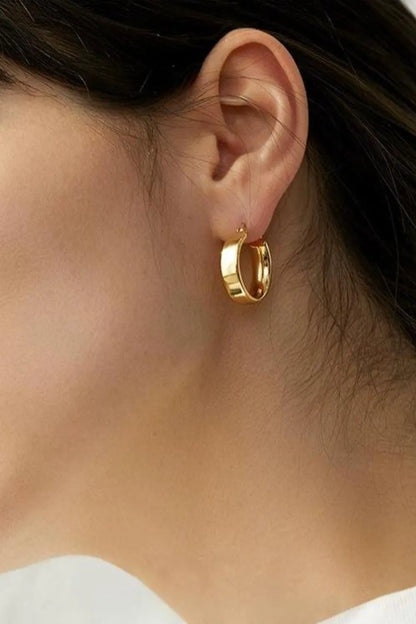 Close-up of affordable gold hoop earrings worn by a model for a stylish look