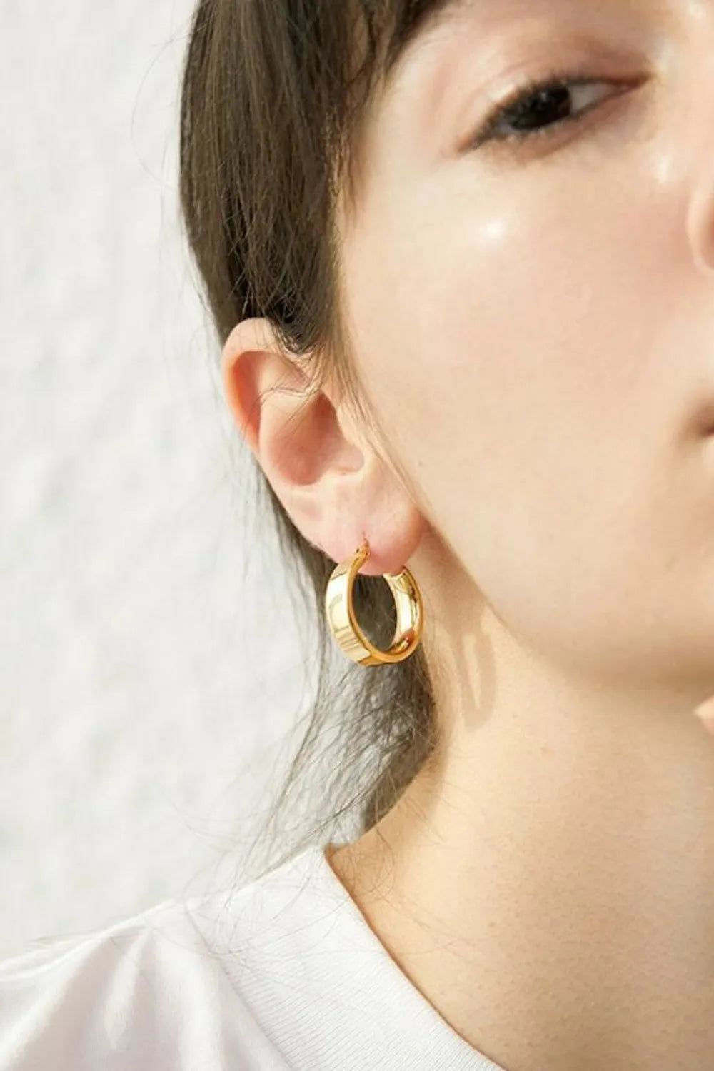 Trendsi affordable gold hoop earrings worn by a model showcasing sleek and stylish design