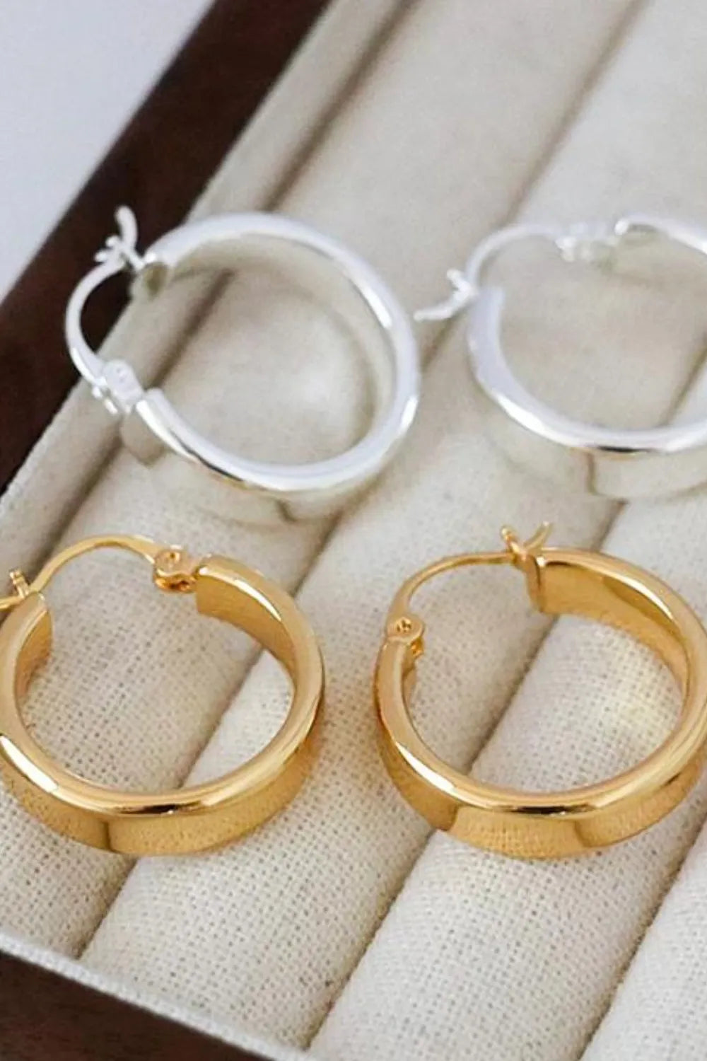 Affordable gold hoop earrings paired with silver hoops in elegant jewelry display