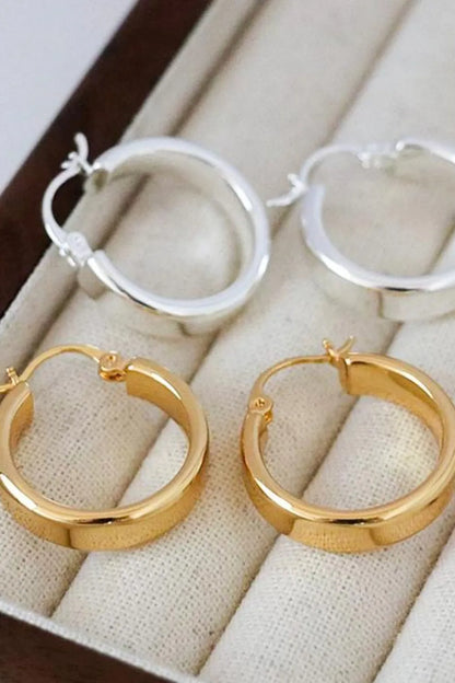 Affordable gold hoop earrings paired with silver hoops in elegant jewelry display