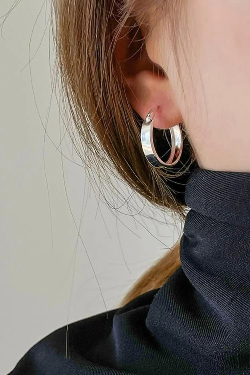 Trendsi affordable gold hoop earrings with a sleek and stylish design worn on a model's ear