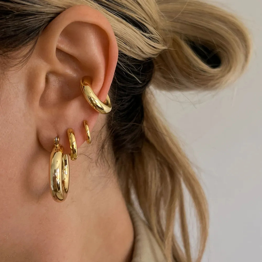 Trendy clip on earrings for women in gold featuring a stylish hoop design