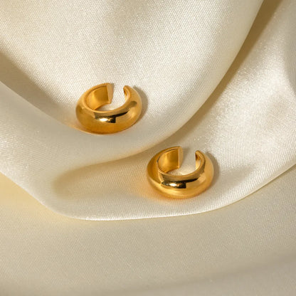 Gold Clip On Earrings for Women in a Sleek Curb Design on Cream Fabric