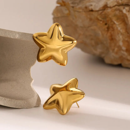 Dazzle collection star earrings in shiny gold with a smooth surface and playful design