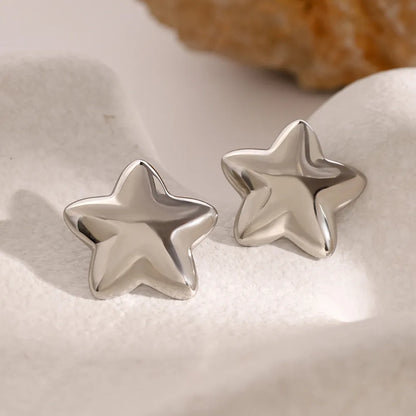 Trendy Dazzle Collection star earrings in shiny silver finish for stylish accessorizing