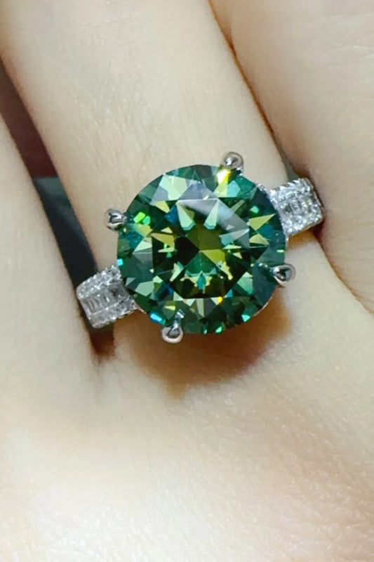 Glamorous green gemstone ring with a sparkling center stone and silver band for elegant style