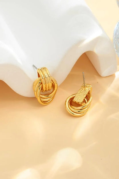 Stylish gold-plated knot stud earrings featuring a modern twisted design for elegant accessorizing