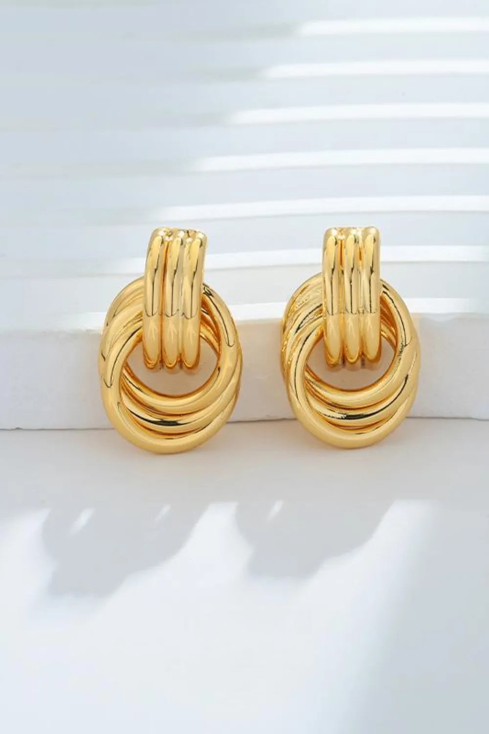 Trendsi gold-plated knot stud earrings featuring a unique intertwined design for elegant styling