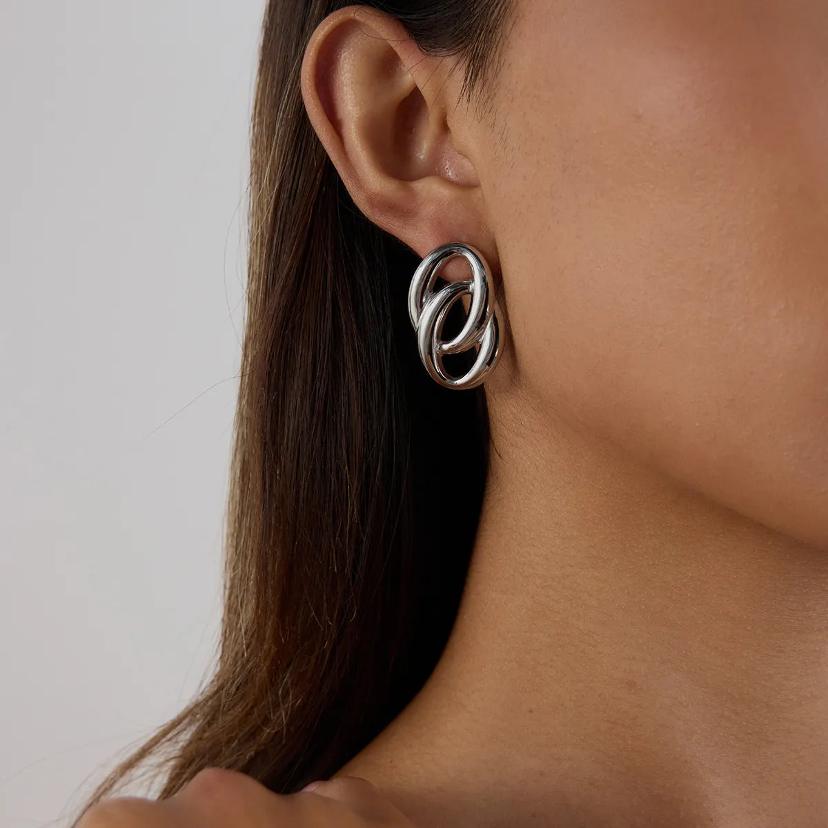 Trendsi modern twist hoop earrings showcased on a model's ear for stylish elegance