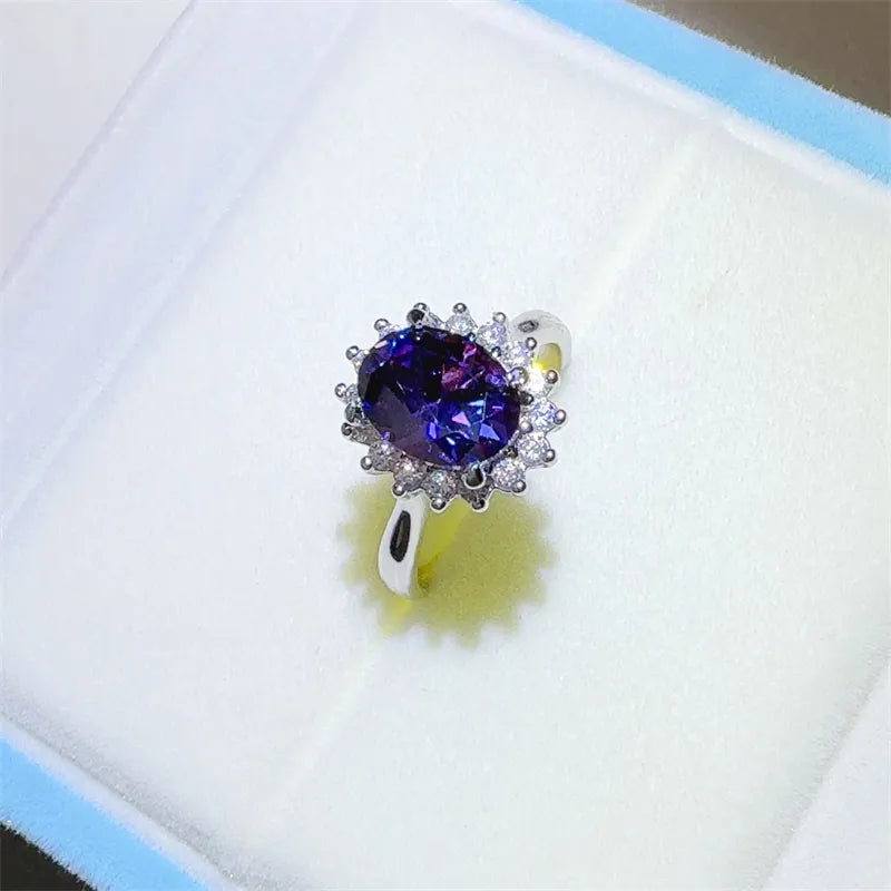 Stunning 2 carat moissanite ring with a rich purple gemstone surrounded by sparkling accents