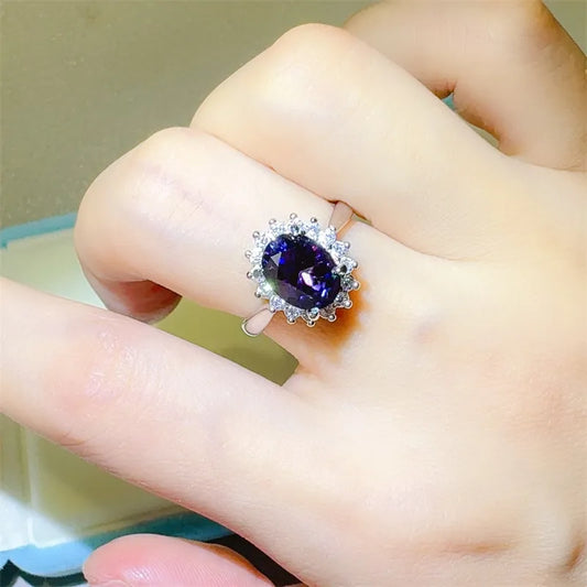 Elegant 2 carat moissanite ring with a stunning oval purple center stone and surrounded by sparkling accents