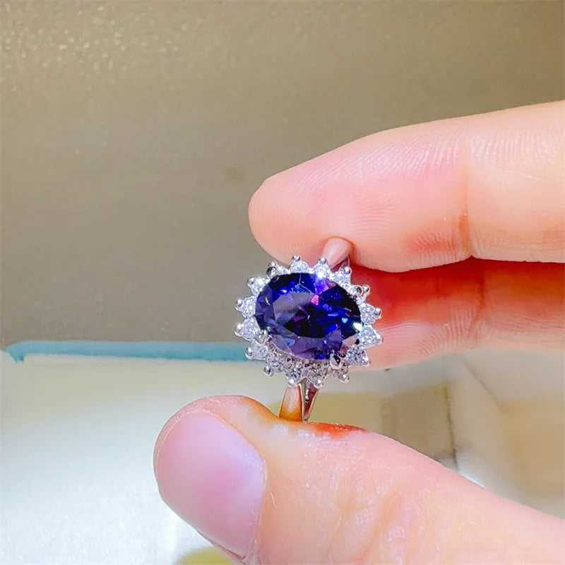 Stunning 2 carat moissanite ring set in silver with detailed floral design and vibrant purple center stone