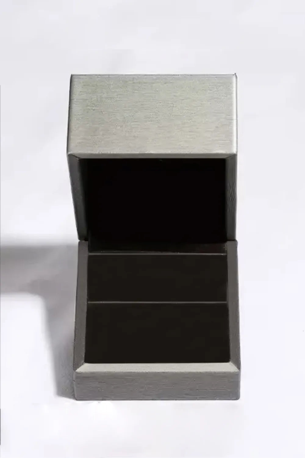 Open silver ring box for displaying a moissanite engagement ring elegantly