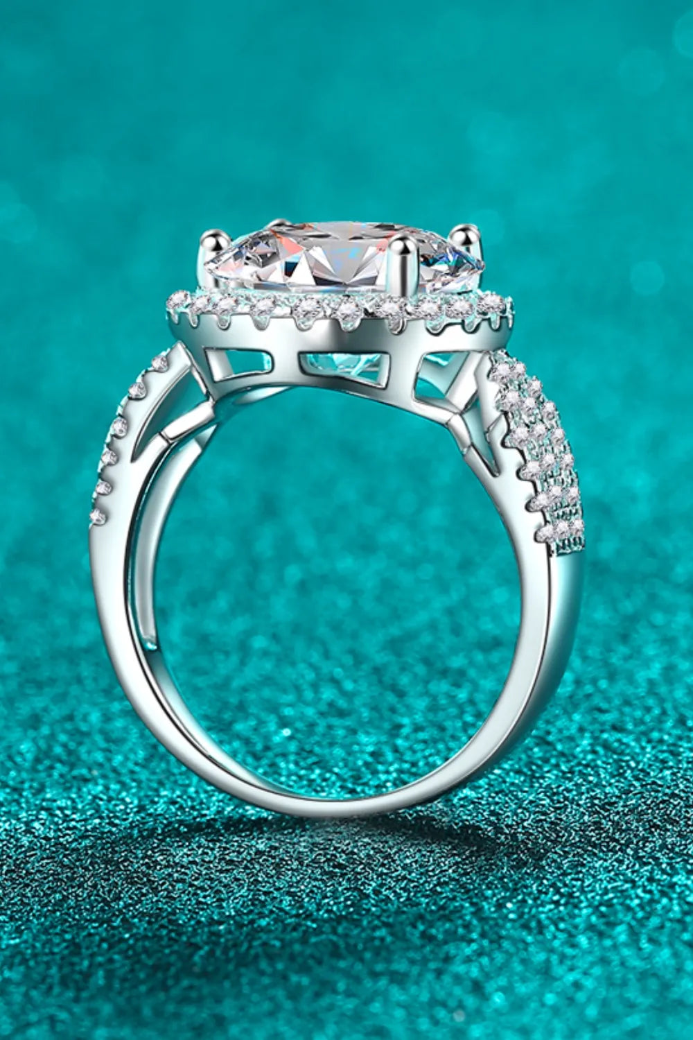 Stunning moissanite engagement ring featuring intricate band design and sparkling accents