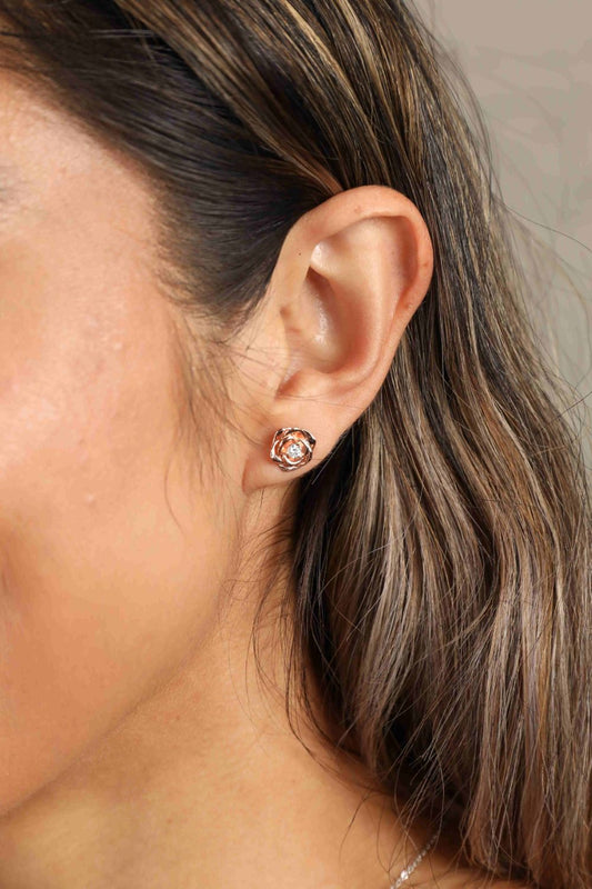 Elegant Moissanite flower earrings worn by a model, showcasing sparkling gemstones in a floral design