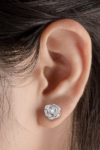 Moissanite flower earrings in silver, showcasing a delicate floral design on an ear