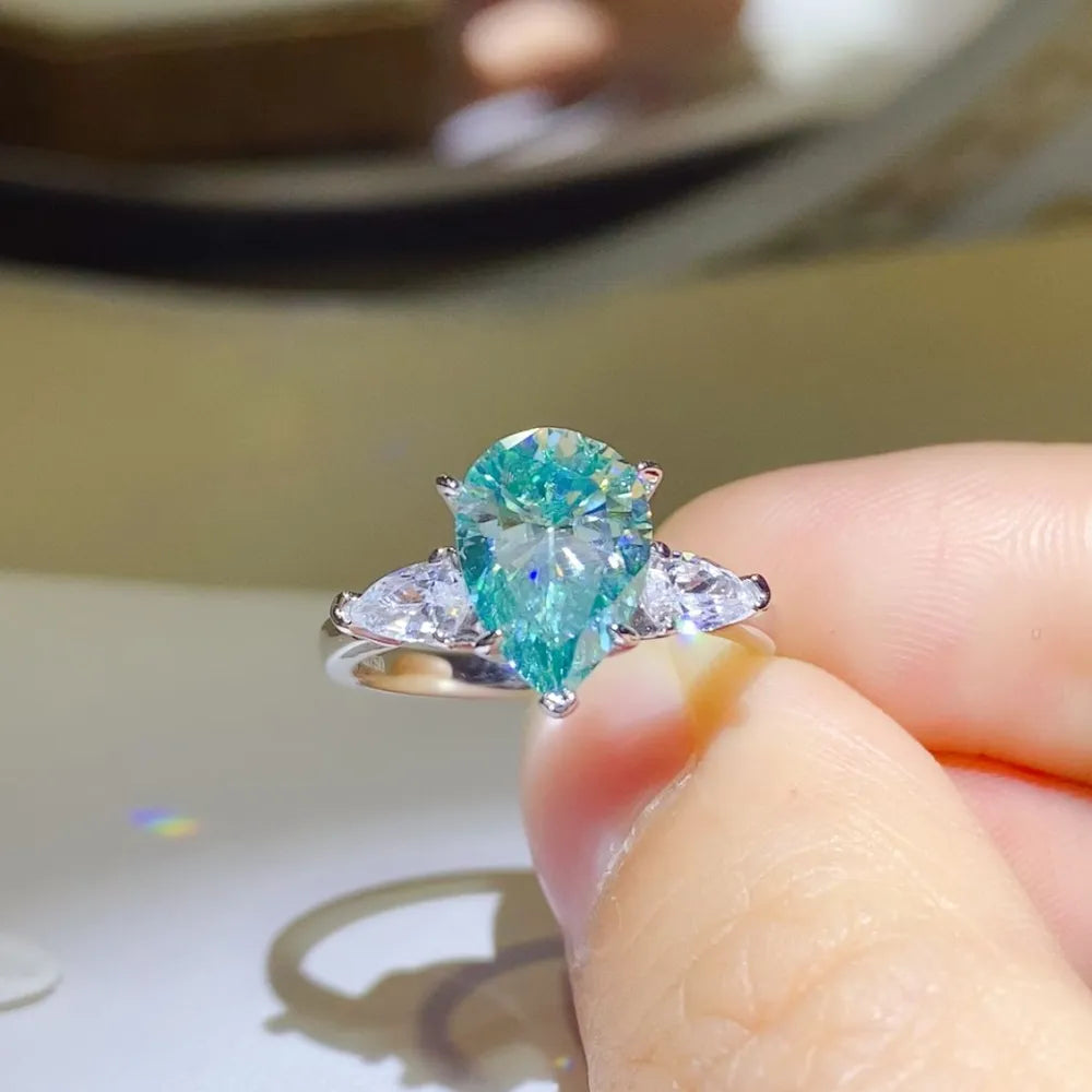 Stunning 2 carat moissanite silver ring featuring a pear-shaped center stone and side accents