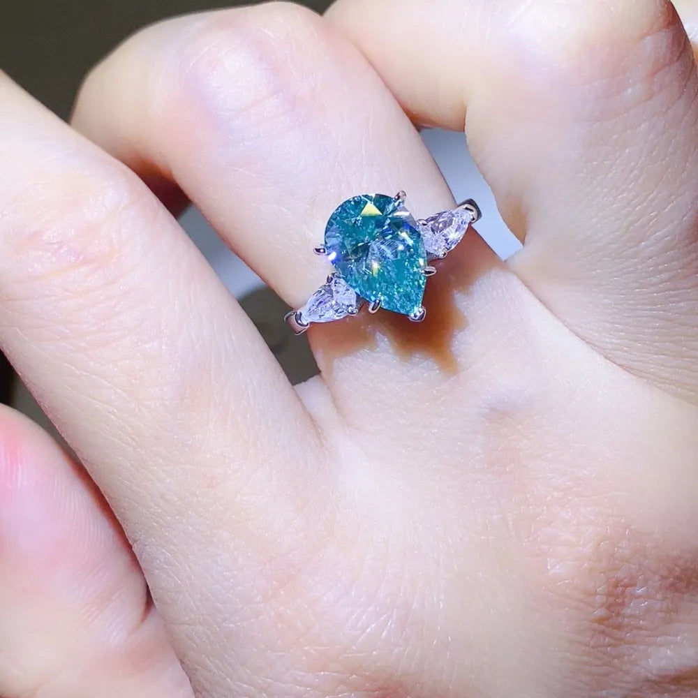 Elegant 2 carat moissanite silver ring featuring a pear-shaped stone with side accents