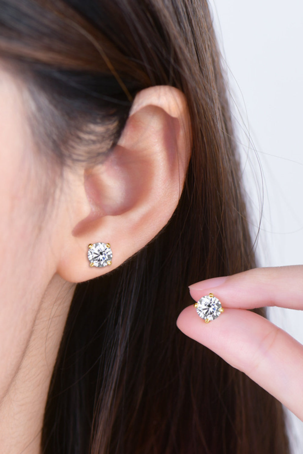 Elegant Trendsi moissanite stud earrings displayed on model's ear for a sparkling look