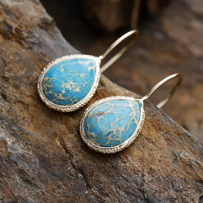 Trendy natural stone drop earrings with turquoise gemstone set in gold-tone metal