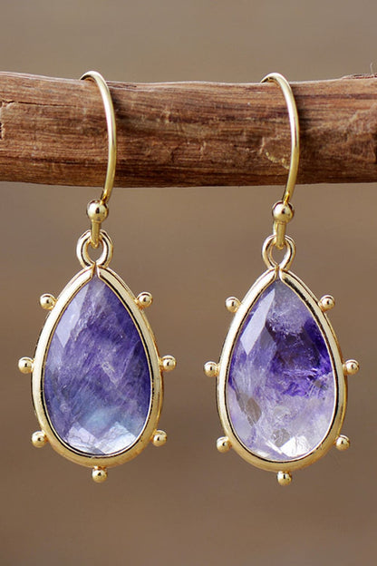 Elegant gold-framed natural stone earrings featuring teardrop-shaped purple stones