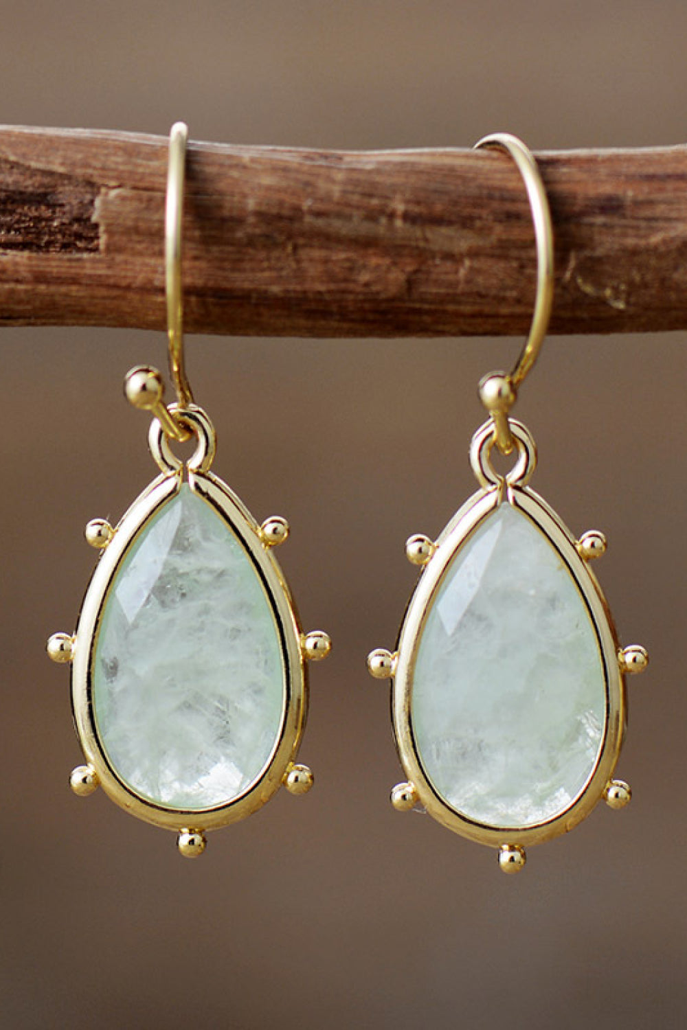 Elegant natural stone earrings featuring teardrop-shaped stones in a gold setting