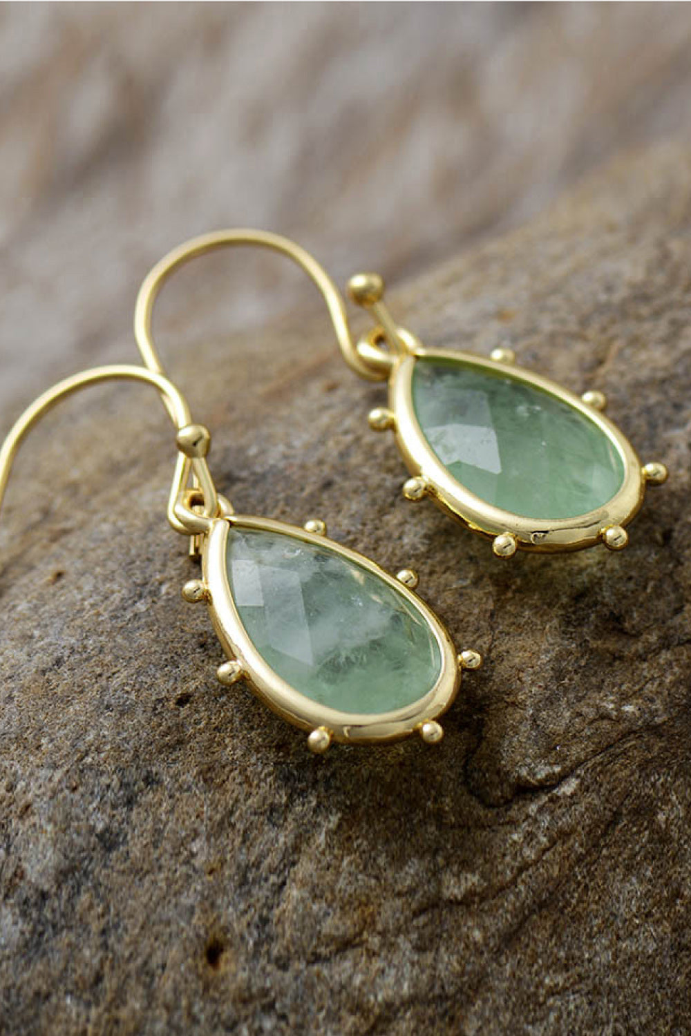 Elegant natural stone earrings with teardrop green stones set in gold for stylish looks