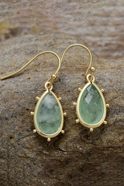 Elegant natural stone earrings featuring green teardrop stones set in gold for a chic look