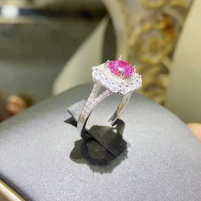 Elegant pink gemstone cocktail ring in silver with intricate detailing and sparkle