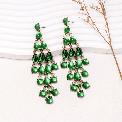 Elegant green teardrop earrings in a cascading design, perfect for formal occasions
