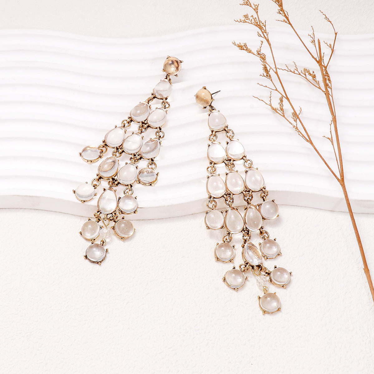 Elegant gold chandelier earrings with teardrop design, perfect for pairing with outfits, featuring red teardrop earrings