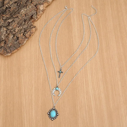 Three-layered turquoise necklace featuring a centerpiece and delicate chains for a stylish look