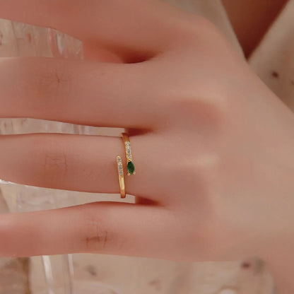 Trendy adjustable ring featuring a delicate design with a green stone and sparkling accents