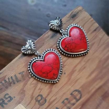 Vibrant red heart earrings with silver detailing, featuring a turquoise heart earrings design