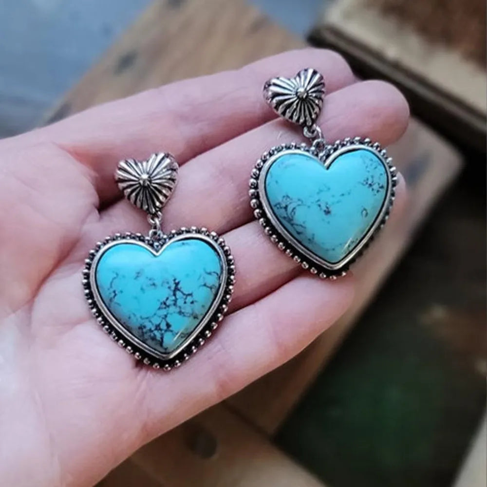 Trendy turquoise heart earrings featuring intricate silver detailing and a charming heart shape