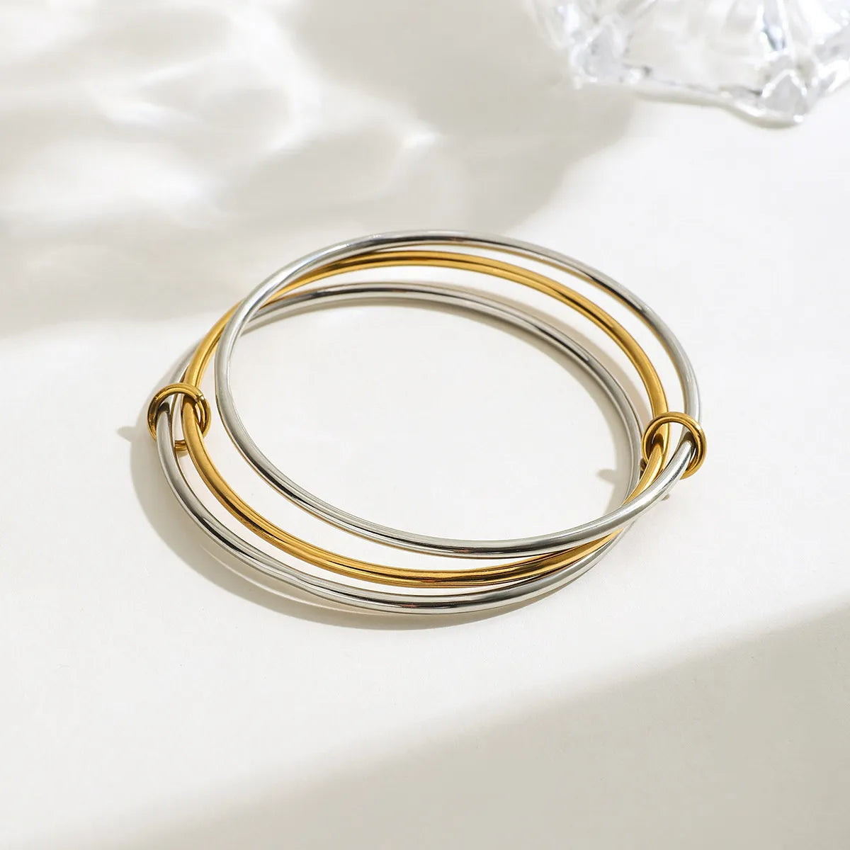 Trendsi two-tone bangle bracelet featuring intertwined silver and gold bands for a stylish look