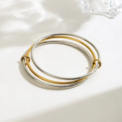 Trendsi two-tone bangle bracelet featuring intertwined silver and gold bands for a stylish look