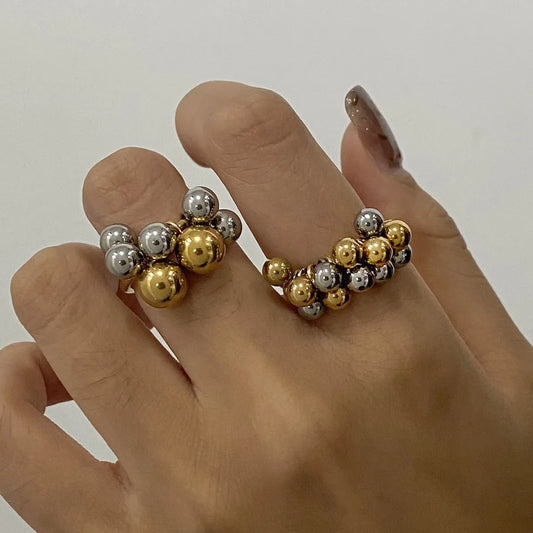 Trendy two-tone bubble cluster ring showcased on model's hand, featuring silver and gold beads