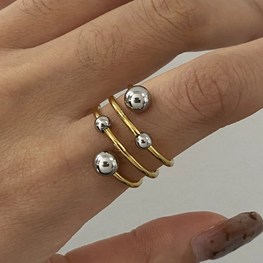 Two-Tone Spiral Ring with Glossy Gold and Silver Balls for Modern Jewelry Style