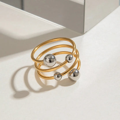 Trendsi two-tone spiral ring featuring gold and silver bands with decorative spheres